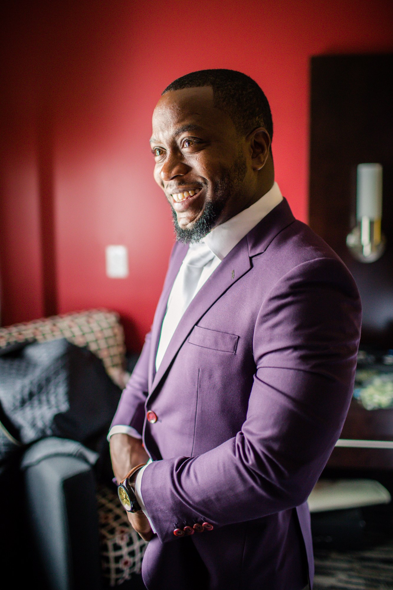Groom smiling in a purple wedding suit