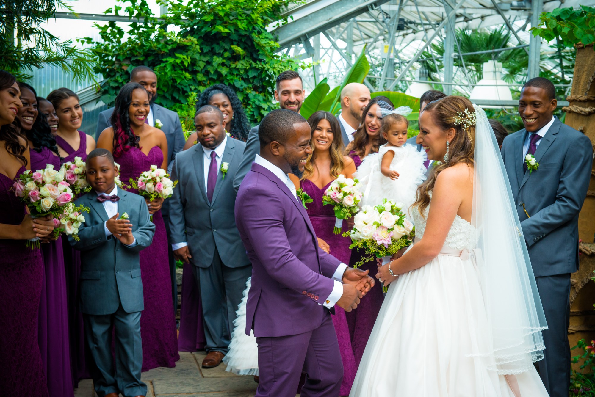 Wedding party gathered in a lush garden